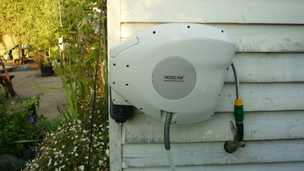 Hoselink Retractable Reel mounted onto a wooden building